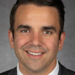 Smiling headshot of Scott Vandermoon in professional dress.