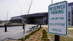 Electric vehicle parking sign outside The Sonnentag Center, supporting sustainable transportation on the UW-Eau Claire campus.