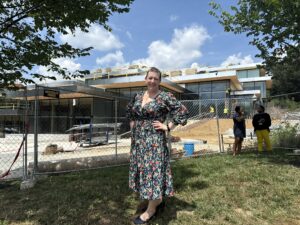 Woman standing in front of Johns Hopkins University Student Center while under construction.