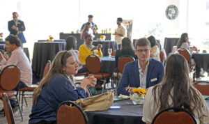 Campus event planning professionals network during the event.
