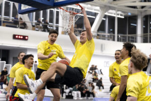 Student performing a dunk during a basketball game at HIWA Recreation Centre.