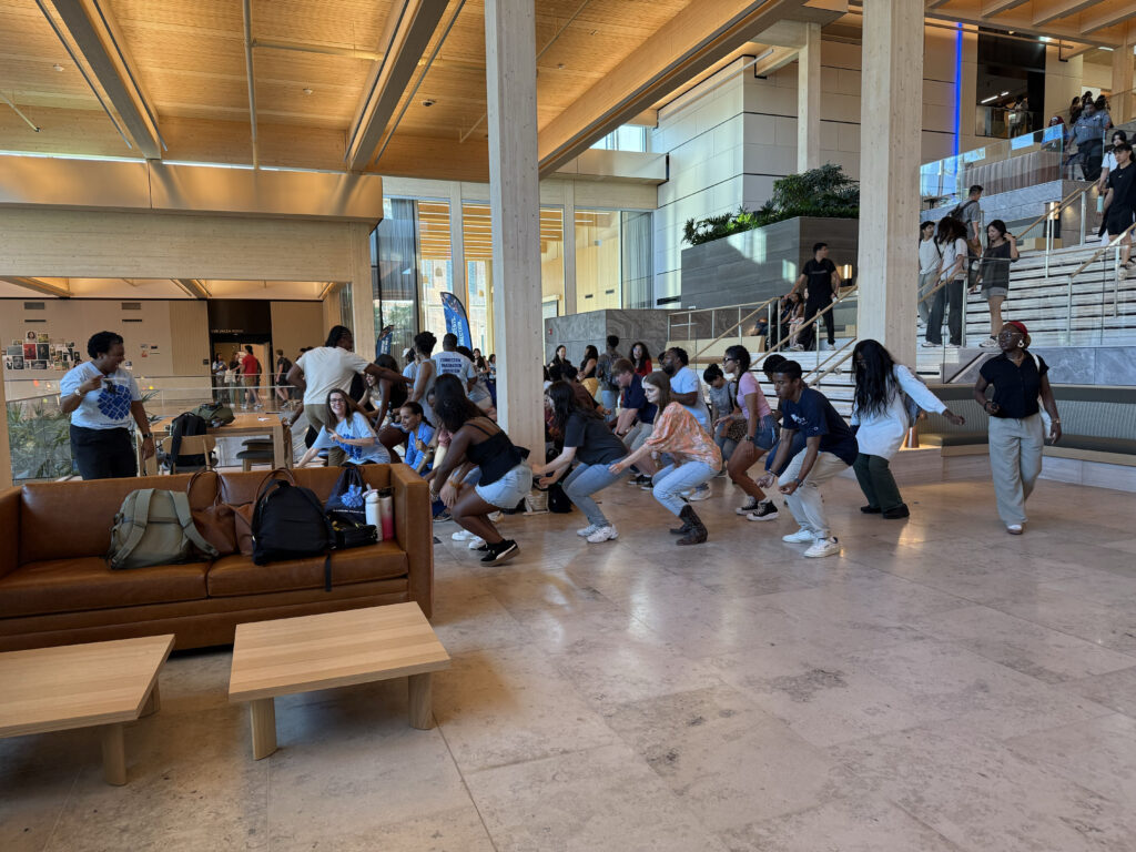 Students and student affairs team dancing in a flash mob inside the Bloomberg Student Center