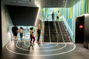 Students exercising on the interior stair track at the HIWA Recreation Centre at the University of Auckland.