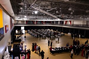 Jacksonville State University Red Tie Gala banquet setup inside campus recreation center gym with formal tables and stage