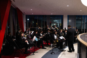 Jazz band performing on indoor track above the Jacksonville State Red Tie Gala in campus recreation center