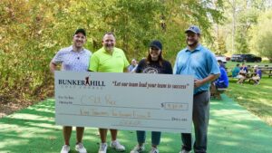 Golf scramble participants presenting scholarship check at Cleveland State University recreation fundraiser